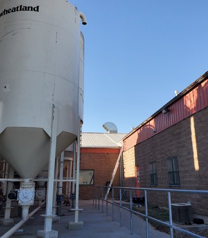 Gutters on a commercial building beside grain silos