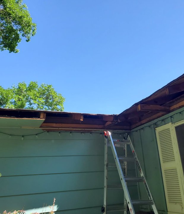 Rotted fascia board behind a gutter before replacement on a Northern Colorado home