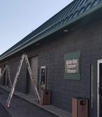 Gutters on a modern dark commercial building with a metal roof