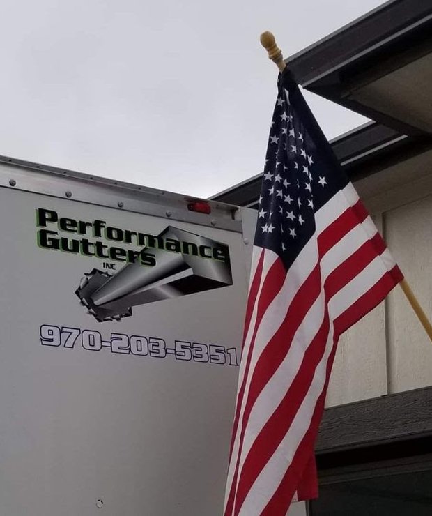 Rob Ware's Performance Gutters truck and trailer with an American flag