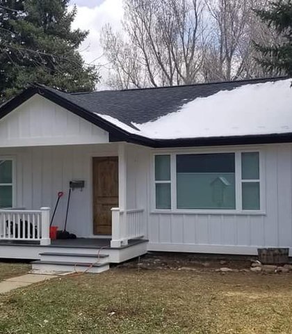 Seamless gutters on a small ranch home in winter